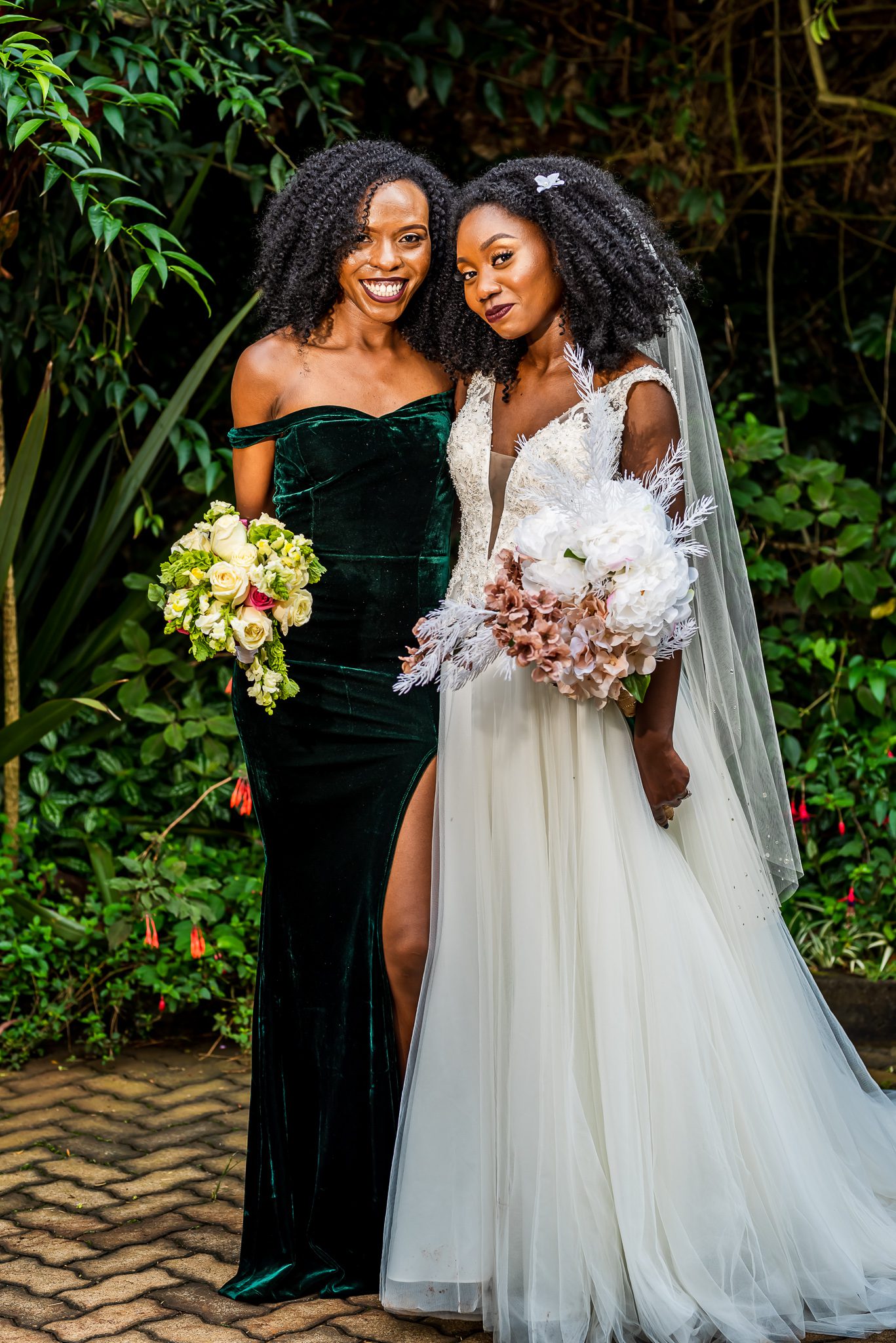 a bride stands next to one of her bridesmaids