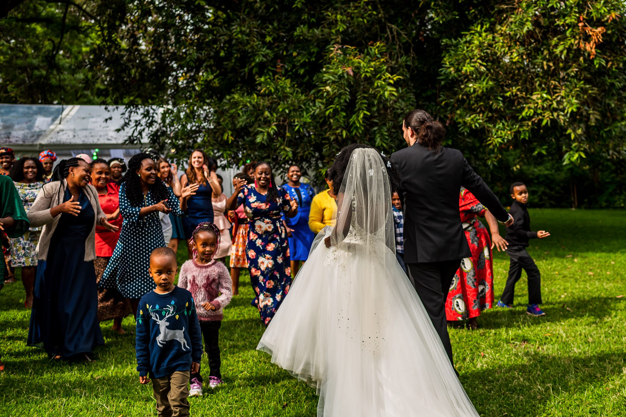 a group of family receives a bride and groom right after the wedding ceremony