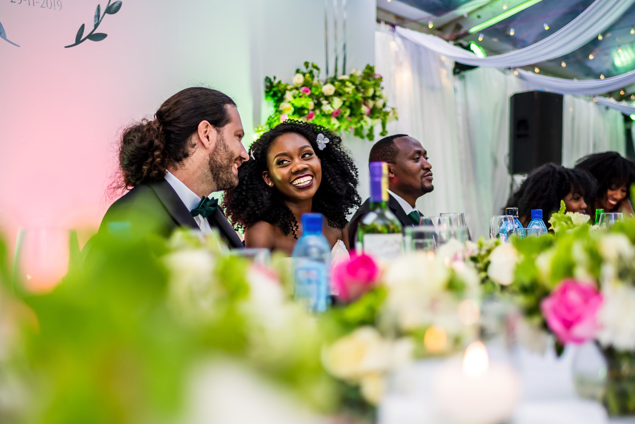 a bride and groom look longingly at each other at their wedding reception in Nairobi, Kenya