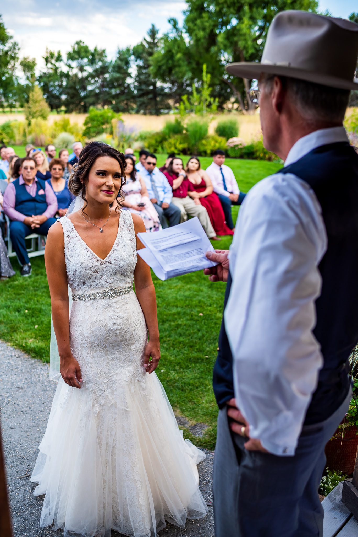A bride looks to her uncle who officiated her wedding at Denver Botanic Gardens Chatfield Farms