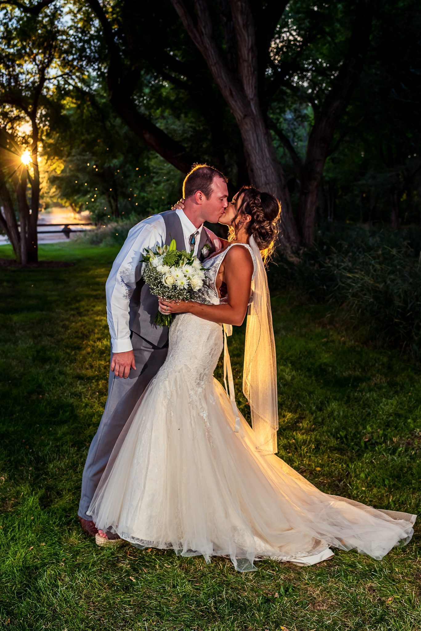 portrait of a bride and groom kissing during golden hour
