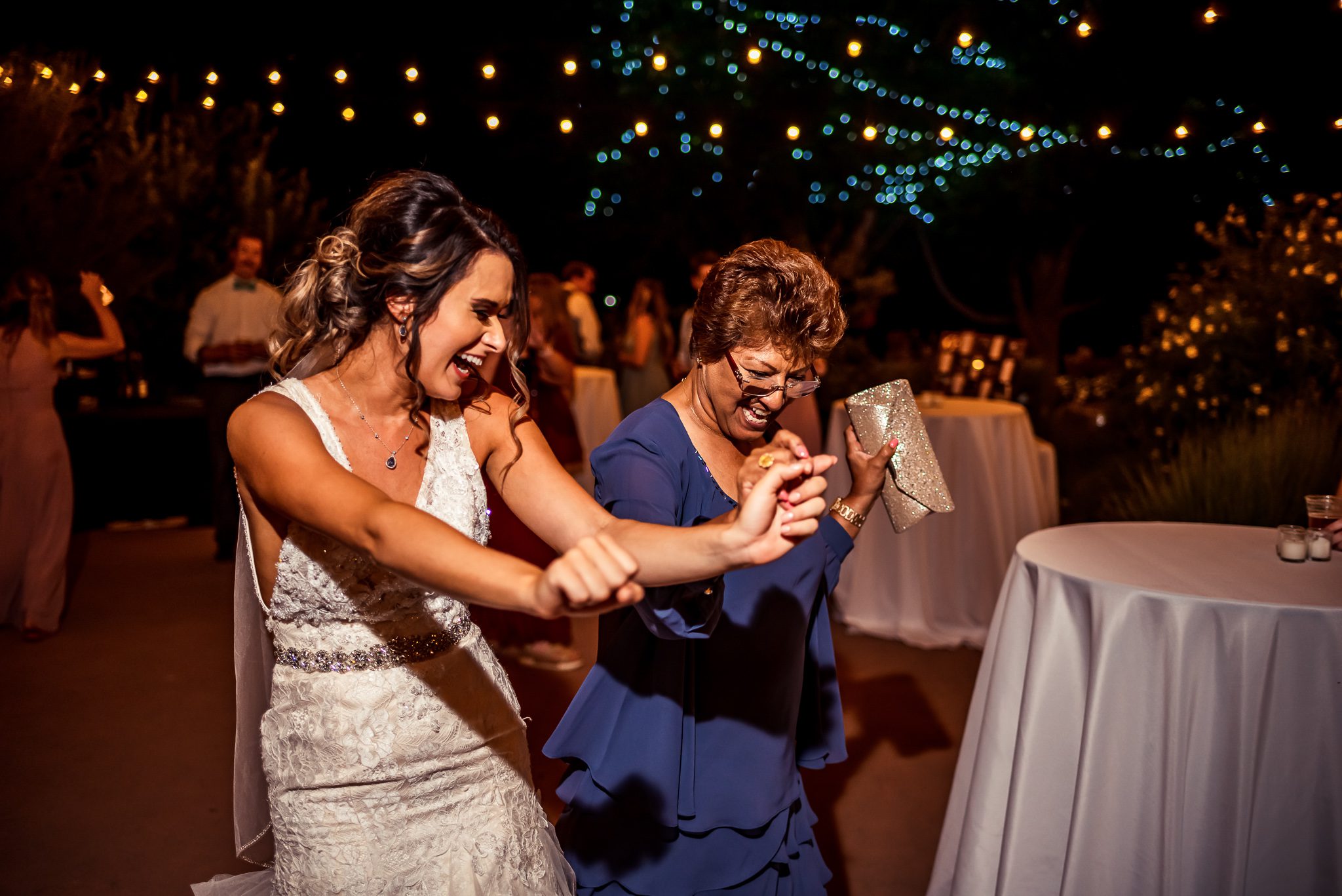 bride dancing with mother on wedding day